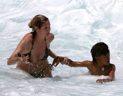 a few weeks ago, the model heidi klum rescued her seven year old son henry from a riptide off the coast of the hawaii island where the family vacationed.  i would jump right in the water too if my son's life was in danger. . . of course, i wouldn't look as great!